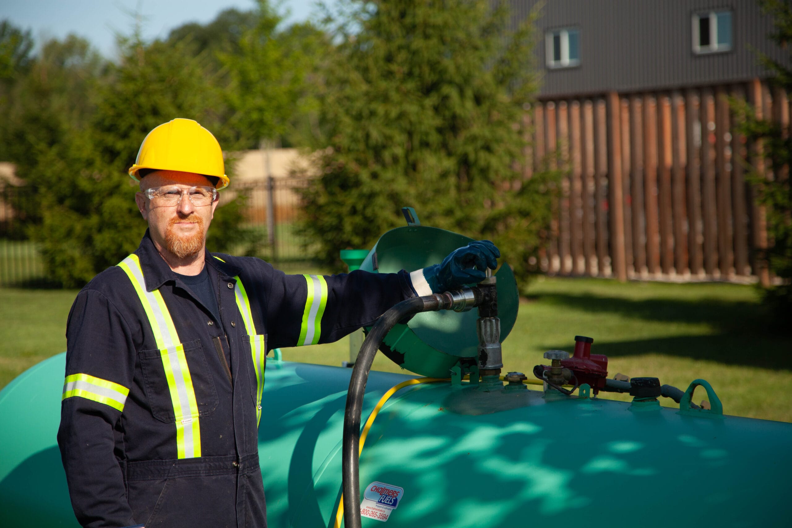 Fuel truck driver filling a propane tank